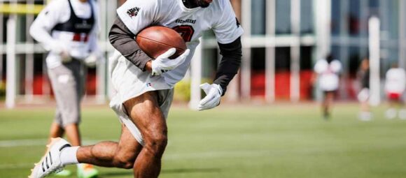 Emeka Egbuka runs with the ball during Tampa Bay Buccaneers practice