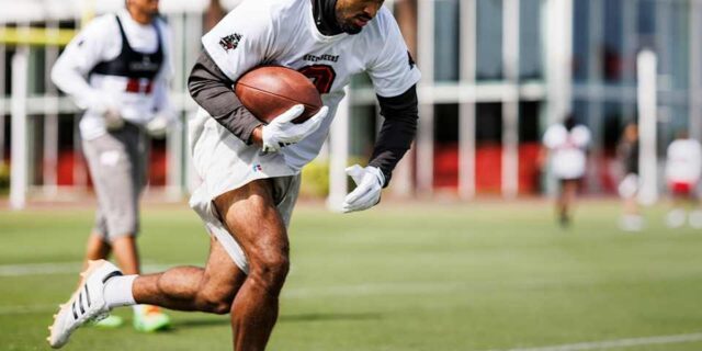 Emeka Egbuka runs with the ball during Tampa Bay Buccaneers practice