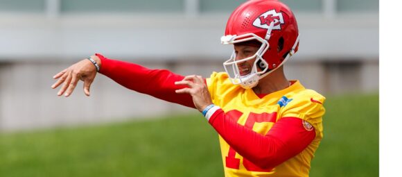 Patrick Mahomes throws during Kansas City Chiefs OTAs on May 26, 2026 with a brace on his left knee while rehabbing a torn ACL.